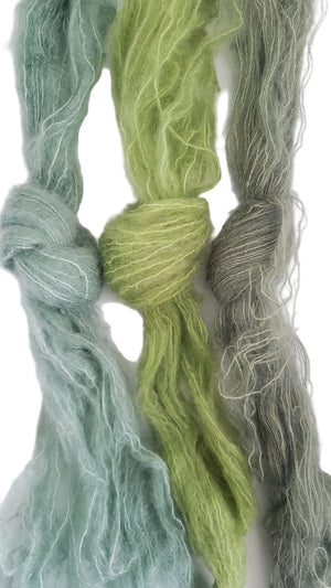 Green and gray yarn skeins on a white background